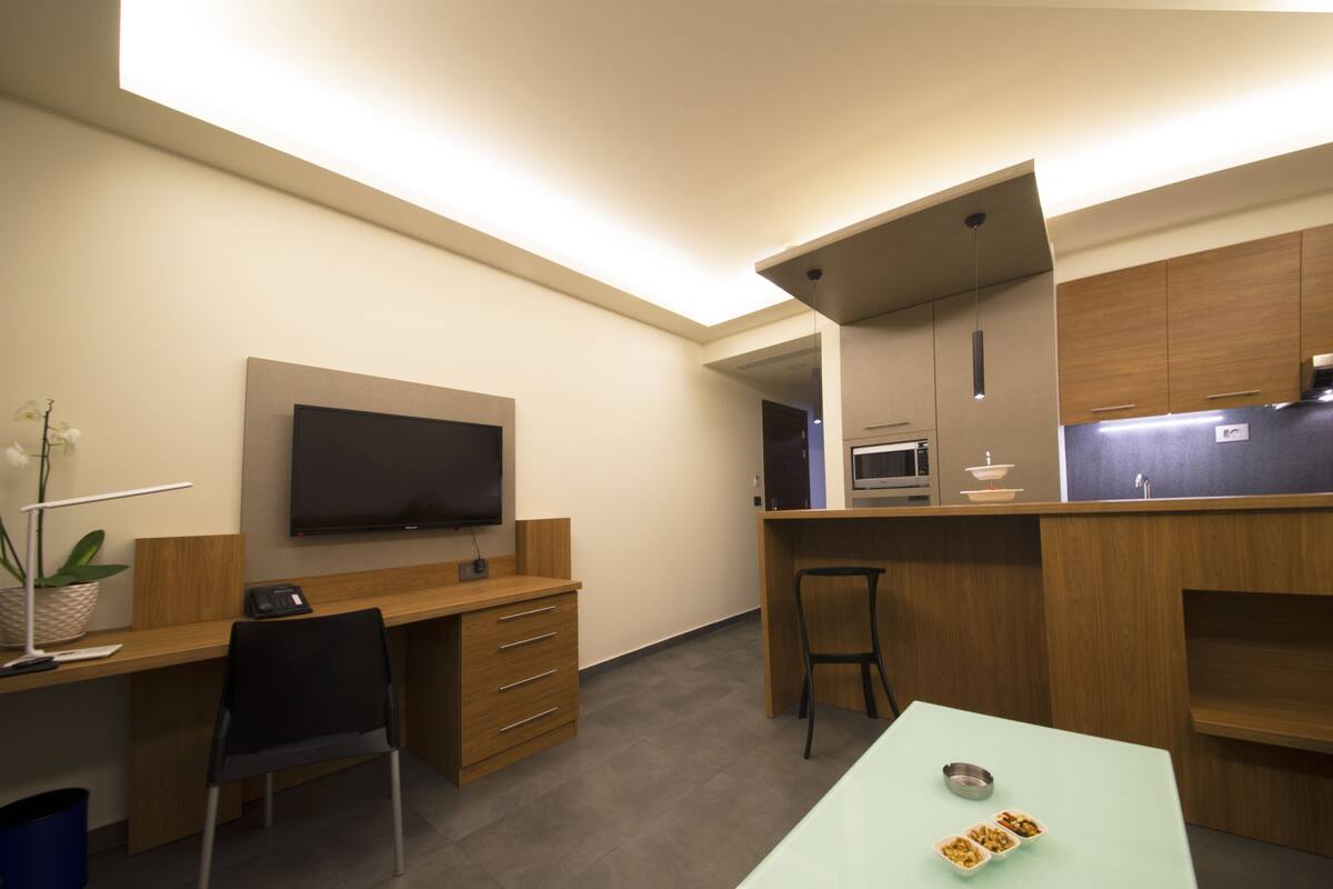 deluxe one bedroom suite, with balcony | living area | 40-inch led tv with satellite channels, tv, fireplace