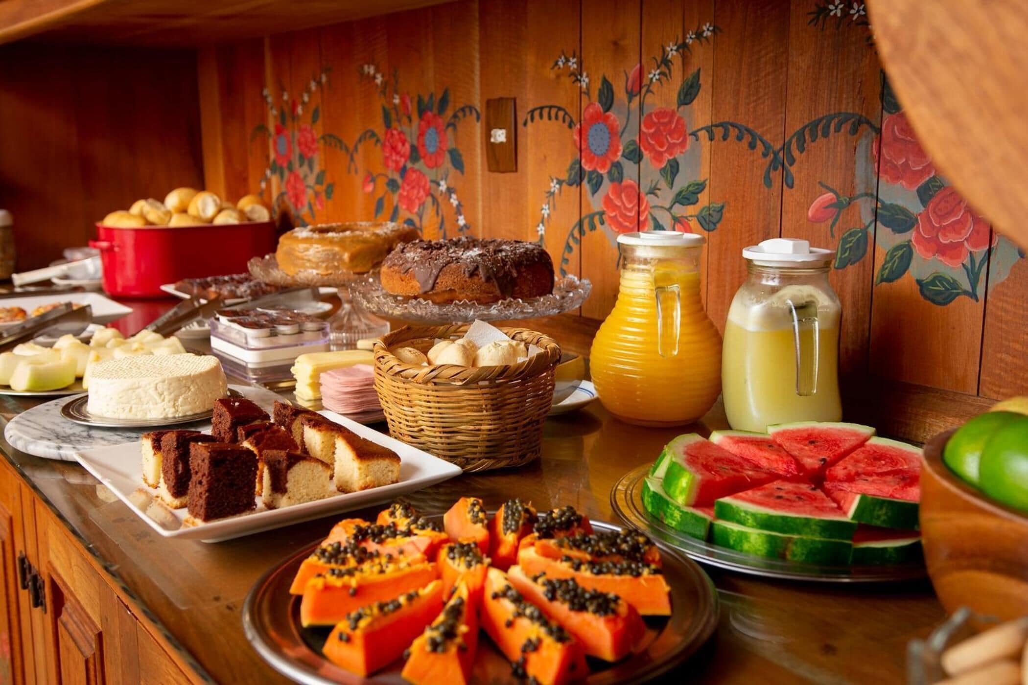 A buffet with various food items including cakes, pastries, and fruits.