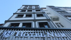 A hotel with a modern facade, large windows, and a prominent "HOTEL NUR" sign. - Nur Hotel (Trabzon)
