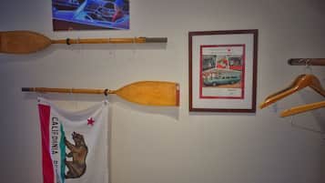 Eine Wand mit diversen Gegenständen, darunter ein Holzschläger, ein gerahmtes Werbeplakat und eine Flagge.