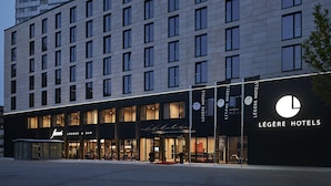 A hotel with a modern facade, a lounge & bar area, and a prominent signage for 'Légère Hotels'. - LEGERE HOTEL Bielefeld (Bielefeld)