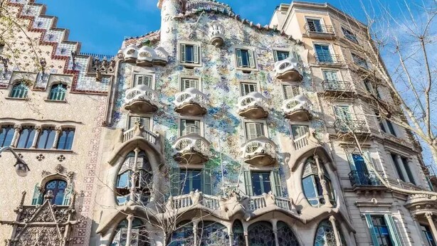Un edificio con balcones ornamentales y detalles arquitectónicos elaborados.