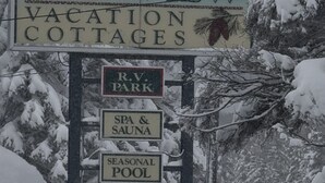 A sign for Glenview Vacation Cottages advertising amenities like RV Park, Spa & Sauna, Seasonal Pool, and Daily or Weekly rates.