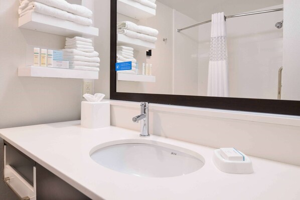 A modern bathroom with a large mirror, white sink, and towel racks. - Hampton Inn Pittsburgh/ Wexford-Sewickley (Sewickley)
