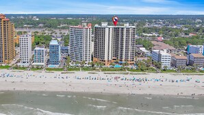 A beachfront hotel with multiple high-rise buildings, a sandy beach, and a view of the ocean. - Units at Patricia Grand Resort by Elliott Beach Rentals (Myrtle Beach)