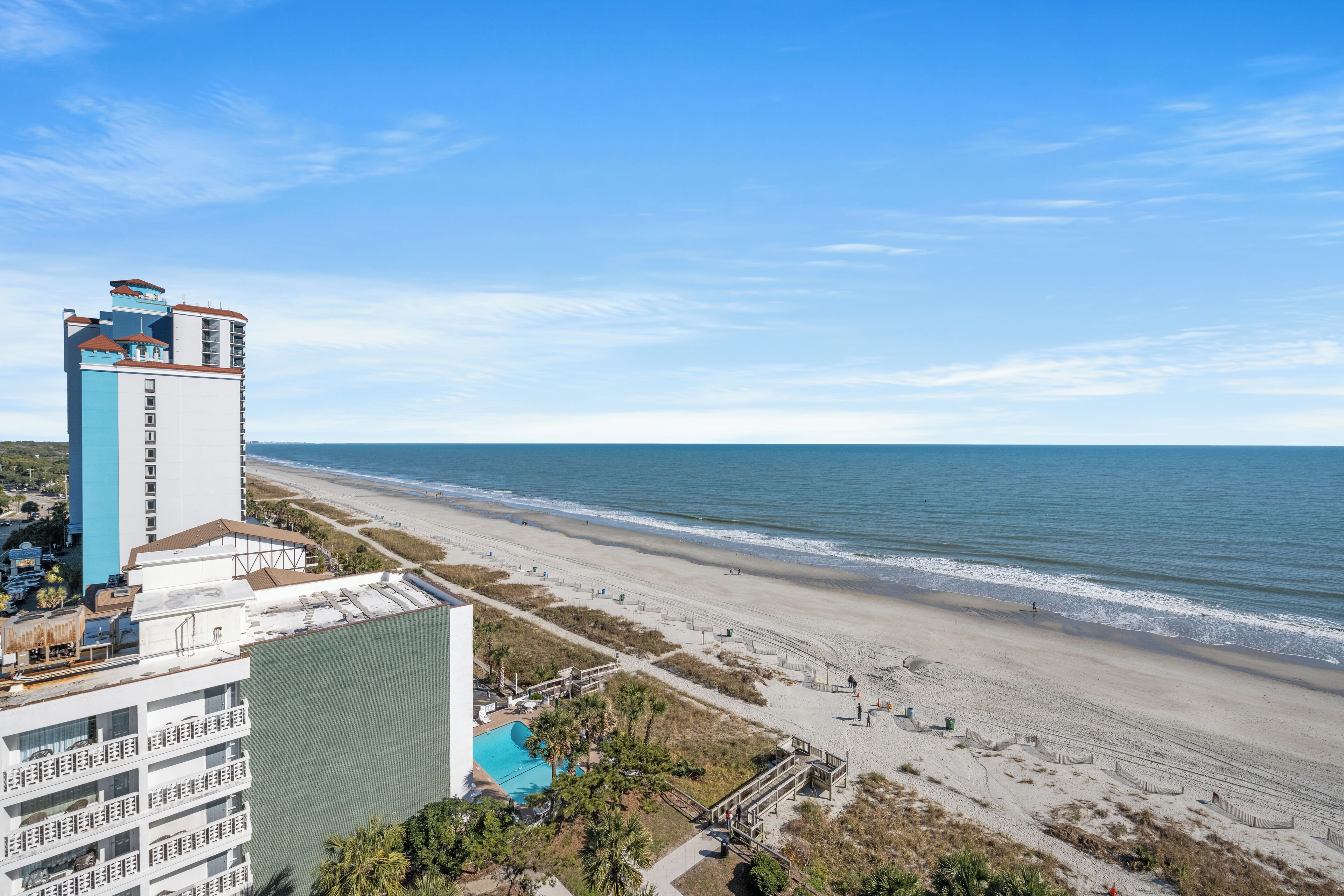 A beachfront hotel with a pool, beach access, and ocean views.