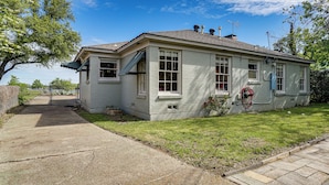 A single-story house with a front porch, a garage, and a small front yard. - Work & Play in Fort Worth! Retro Home 5 Mi to TCU (Fort Worth)