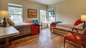 A room with two beds, a desk, a chair, and a ceiling fan. - Work & Play in Fort Worth! Retro Home 5 Mi to TCU (Fort Worth)