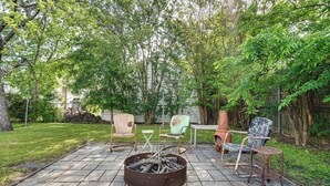 A patio area with a fire pit, outdoor furniture, and a grassy lawn. - Work & Play in Fort Worth! Retro Home 5 Mi to TCU (Fort Worth)