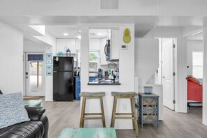 A modern apartment with a kitchen, living area, and a staircase. - Cozy Melbourne Retreat | Indian river | Beaches (Melbourne)