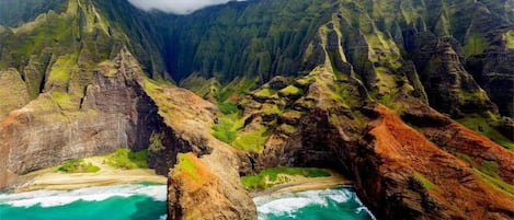 A coastal landscape with rugged cliffs and turquoise waters.