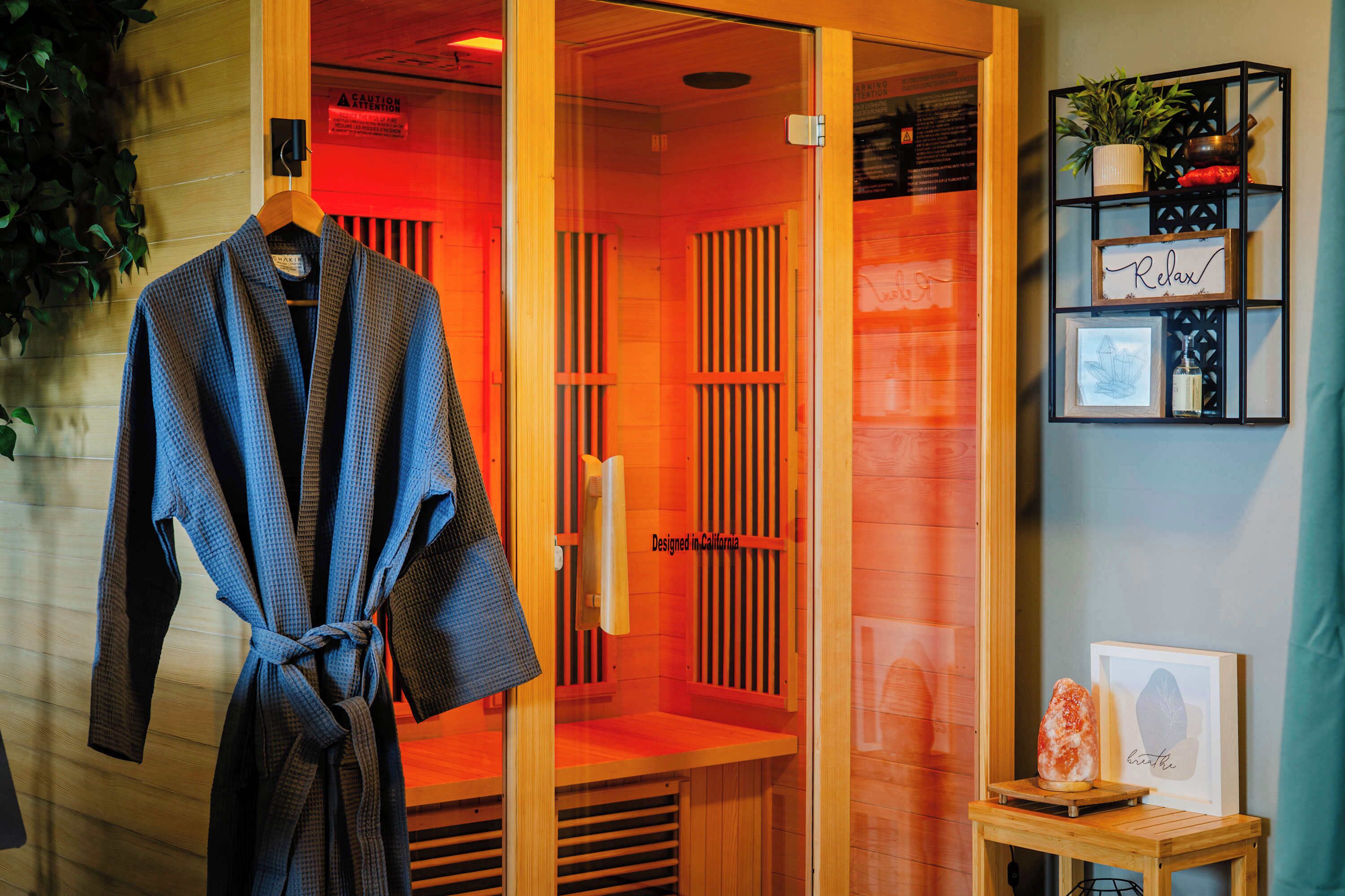 A sauna with wooden panels and a towel rack.