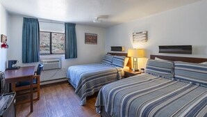 A hotel room with two beds, a desk, a chair, a lamp, and a window with curtains. - Clean, Modern & Close to Everything Double Room At Silversage Inn (Moab)