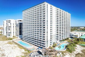 A high-rise hotel with multiple balconies, a pool area, and a beach view. - 312 Gorgeous Gulf Views w/ 25’ Private Balcony ~ Pool ~ Hot Tub ~ Book Aug 10th (Destin)
