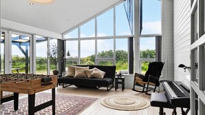 A spacious room with a foosball table, a sofa, a rocking chair, and a piano. - VillaVilla 954 - Fjaltring-Trans, Vestjylland (Lemvig)