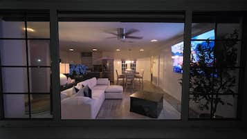 A modern living room with a sofa, coffee table, and TV.