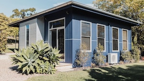 A modern building with a flat roof, large windows, and a small front porch. - Studio 22: Garden Serenity & Coastal Calm (Port Lincoln)