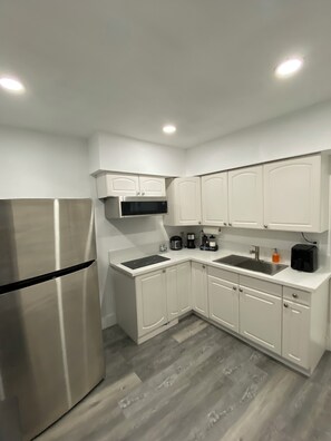 A modern kitchen with white cabinetry, a stainless steel refrigerator, a microwave, and a coffee maker. - Lovery private room 2BR.2 miles form Las Vegas strip and airport  (Las Vegas)