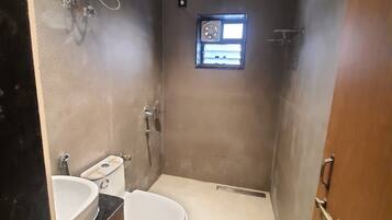 A bathroom with a toilet, bidet, and sink.