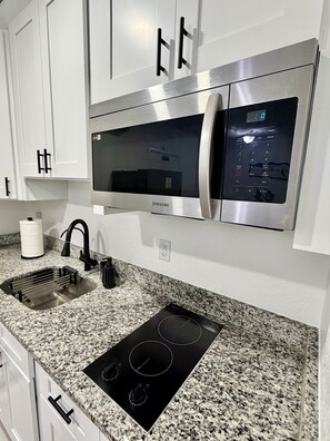 Fridge, microwave, stovetop, coffee/tea maker