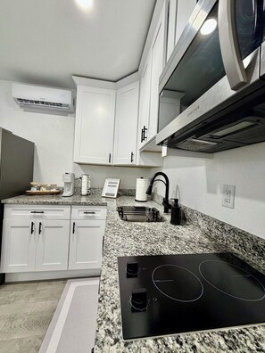 Fridge, microwave, stovetop, coffee/tea maker