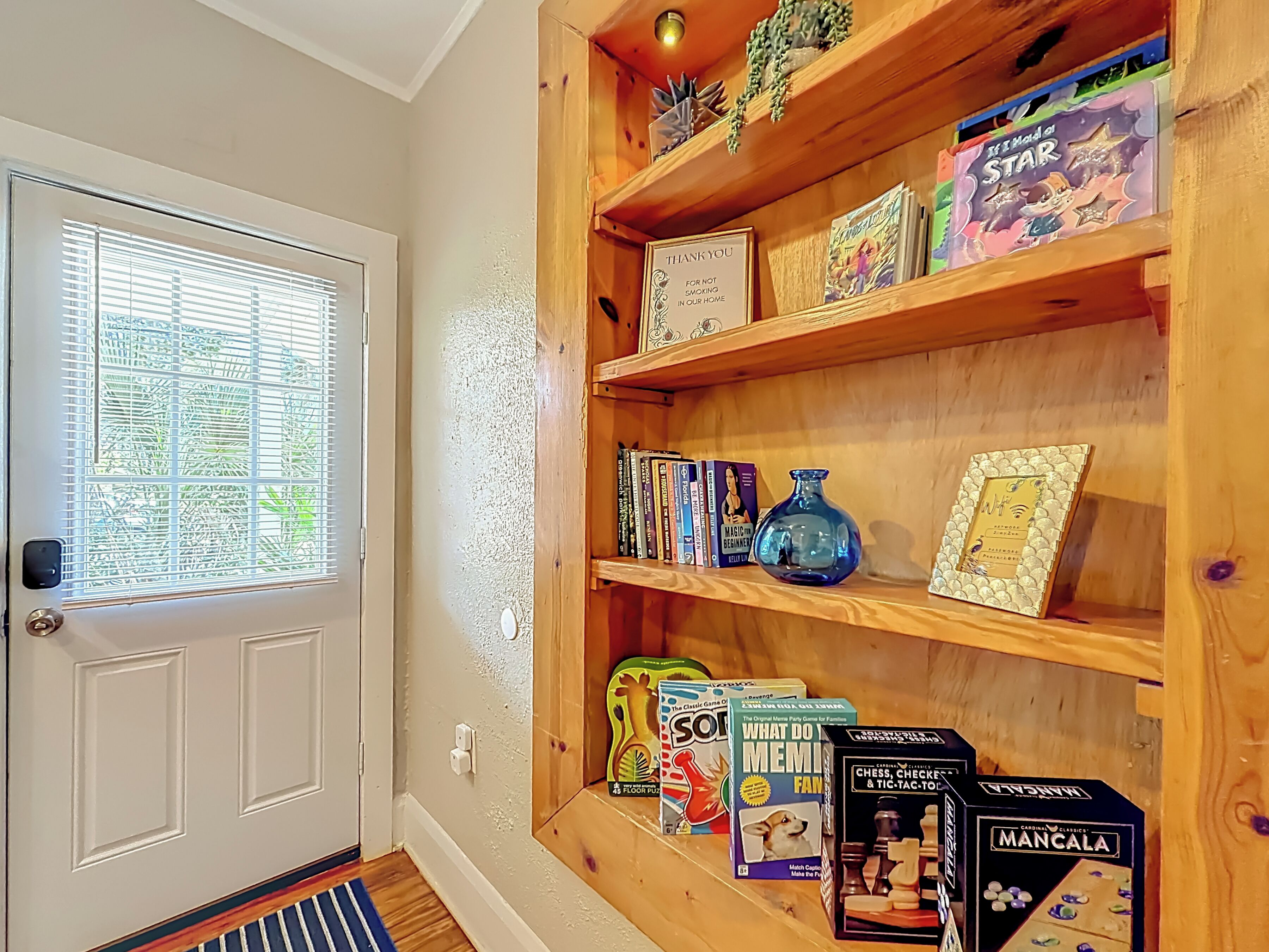 A wooden bookshelf with various board games and books.