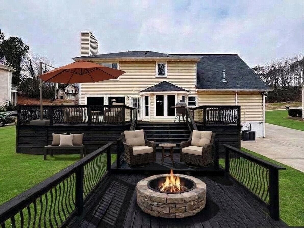 A deck with outdoor furniture, a fire pit, and a covered area with an umbrella.