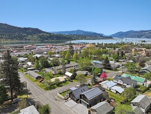 A residential area with houses, a road, and a bridge in the background.
