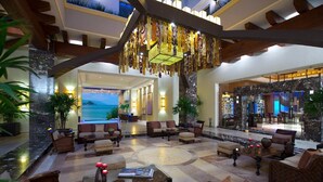 A spacious lobby with a large seating area, a view of the ocean, and a modern chandelier. - 2BR Beachfront at Garza Blanca Vallarta-Oceanfront Resort Living (Puerto Vallarta)