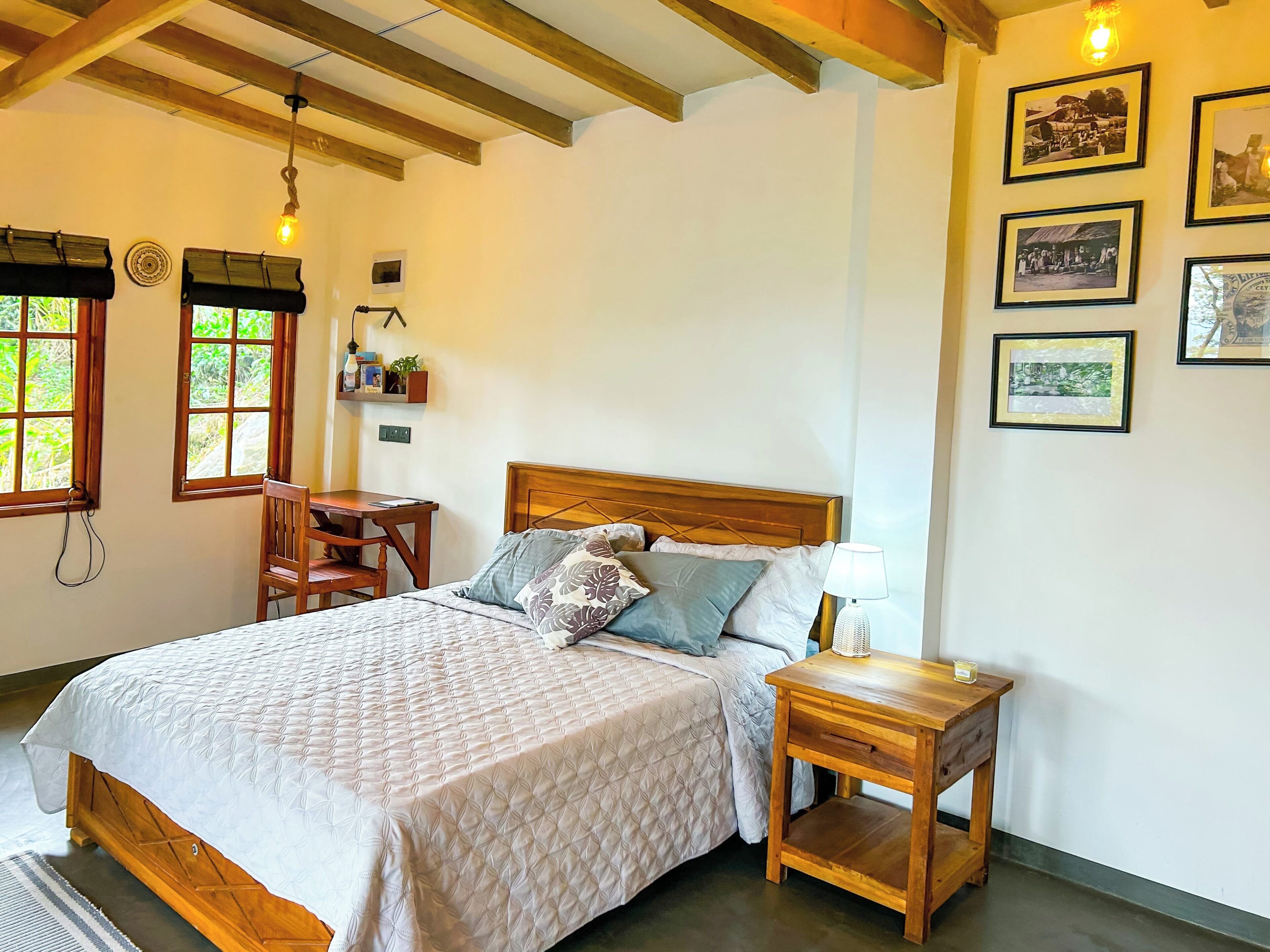 A bedroom with a wooden bed, bedside tables, a desk, and a shelf with items.