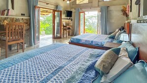 A spacious bedroom with a large bed, a wooden ceiling, and a television. - Unseen Knuckles Eco Boutique  (Tawalanthanna)