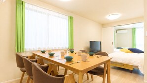 A hotel room with a dining area, a bed, and a TV. - Ars Kiyosumi shirakawa (Tokyo)