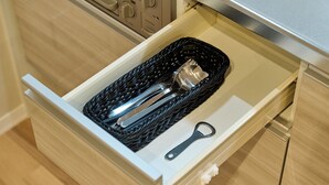 A drawer with a black woven basket containing a metal container and a metal bottle opener. - ShaMaison richelive Yoshizuka by Tranova (Fukuoka)