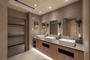 A modern bathroom with two sinks, mirrors, and a towel rack. - KANSO STAY (Seoul)