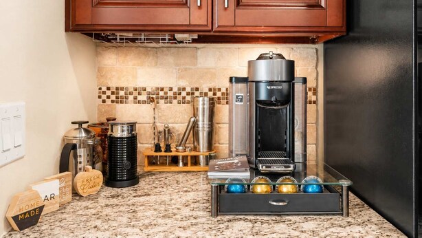 A kitchen with a coffee machine, a coffee grinder, and a coffee maker on the counter. - Private Pool Oasis in Quiet Energy Corridor Villa (Houston)