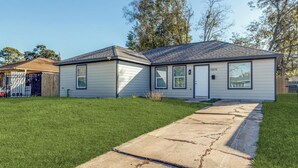 Ein eingeschossiges Haus mit Vordergarten, Auffahrt und Briefkasten.