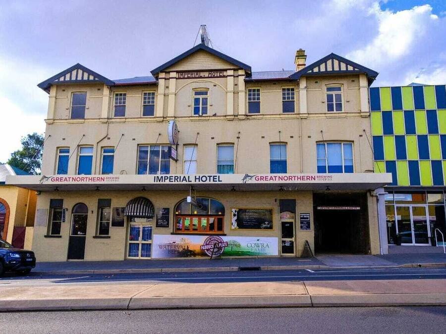 A two-story building with a sign reading 'Imperial Hotel' and 'Great Northern Brewing' on the ground floor.