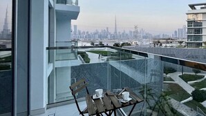 Ein modernes Gebäude mit einem Glasbalkon und Blick auf eine Stadtlandschaft.