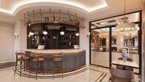 A bar area with a curved counter, bar stools, and a wine rack with bottles and glasses. - Hotel Montmartre de Sapa (Sa Pa)