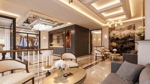 A spacious lobby with a reception desk, seating area, and a decorative wall. - Hotel Montmartre de Sapa (Sa Pa)