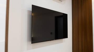 A flat-screen TV mounted on a white wall.
