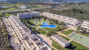 A hotel with multiple buildings, a swimming pool, and a tennis court. - Relax & Play Panoramic Golf Vinaroz (Sant Jordi)