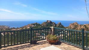 A balcony with a view of rocky terrain and the sea. - A beautiful elevated architect designed villa with breathtaking sea views. (Costa Paradiso)