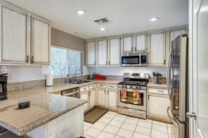 A kitchen with granite countertops, stainless steel appliances, and light wood cabinets. - 8 Mi to Strip! Poolside Desert Escape in Las Vegas (Las Vegas)