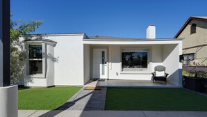 A modern house with a patio, a door, and a window.