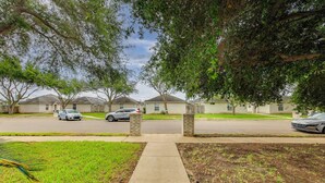 A residential street with houses, a sidewalk, and parked cars. - Pool Access & Work-Ready Comforts! Edinburg Apt (Edinburg)