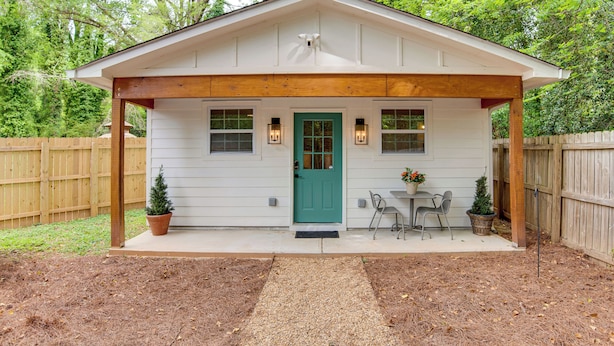 A small house with a porch, a green door, and two windows with exterior lighting. - Couple’s Retreat! 7 Mi to Dtwn Atlanta & Six Flags (Atlanta)