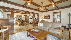 A spacious living area with a wooden ceiling, a sofa, a coffee table, and a dining area with chairs and a table. - 3 Blocks to Plaza! Historic Prescott Gem w/ Grill (Prescott)