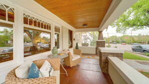 A covered porch with wicker furniture, a small table, and a view of the street. - 3 Blocks to Plaza! Historic Prescott Gem w/ Grill (Prescott)