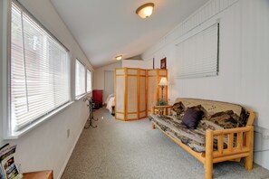 A room with a wooden sofa, a traditional Japanese room divider, a lamp, and a window with blinds. - 'Elk Home' - Yellowstone Basecamp < 1 Mi to Park! (West Yellowstone)